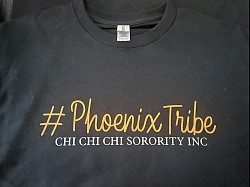 Black shirt with orange writing. #ChiTribe White lettering underneath, Chi Chi Chi Sorority Inc.